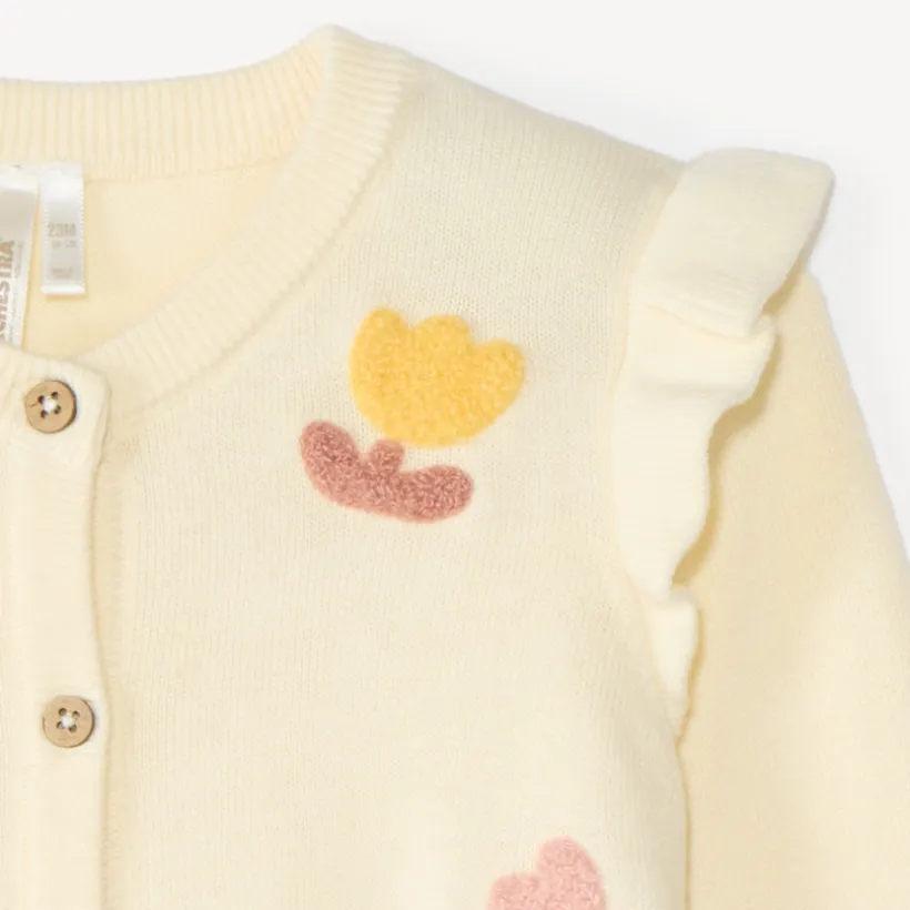 Gebreide stoffen vest voor meisjes met een fantasiepatroon en bouclette-patch.