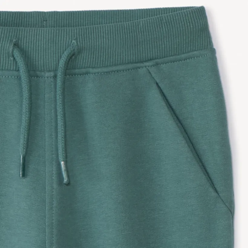 Joggingbroek in effen fleece voor babyjongens met elastische taille en aantrekkoord, twee Italiaanse zakken en aansluitende geribde enkels