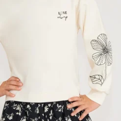 Meisjes jurk van twee materialen met lange mouwen en geborduurde bloemen.