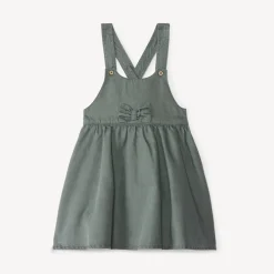 Overgooierjurk met gekruiste bretellen en knoop voor babymeisje
