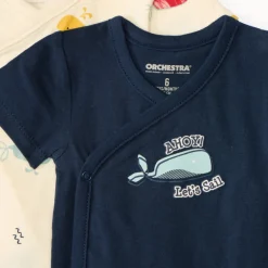 Set van 7 korte mouw rompertjes met maritieme prints voor babyjongens, met verschillende openingen afhankelijk van de leeftijd.