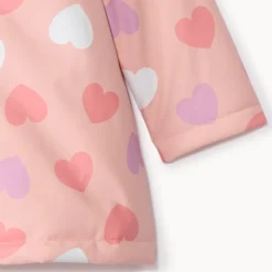 Waterafstotende rozenroze rubberparka met magische hartenprint voor babymeisje